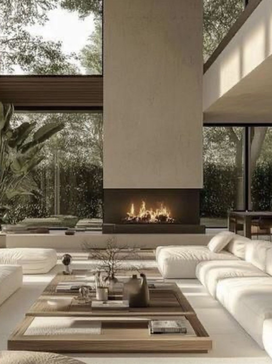 Русский промпт: Современная гостиная с минималистским дизайном с большими окнами, которые предлагают вид на зелень снаружи. Комната снабжена белыми диванами, деревянным журнальным столиком с различными предметами на нем и камином в центре. Стены изготовлены из бетона, а пол покрыт светлым ковром. Освещение мягкое и естественное, создавая успокаивающую атмосферу. Общая эстетика является современной и привлекательной. | Original prompt: A modern living room with minimalist design, featuring large windows that offer a view of the greenery outside. The room is furnished with white sofas, a wooden coffee table with various objects on it, and a fireplace in the center. The walls are made of concrete, and the floor is covered with a light-colored carpet. The lighting is soft and natural, creating a calming atmosphere. The overall aesthetic is contemporary and inviting.