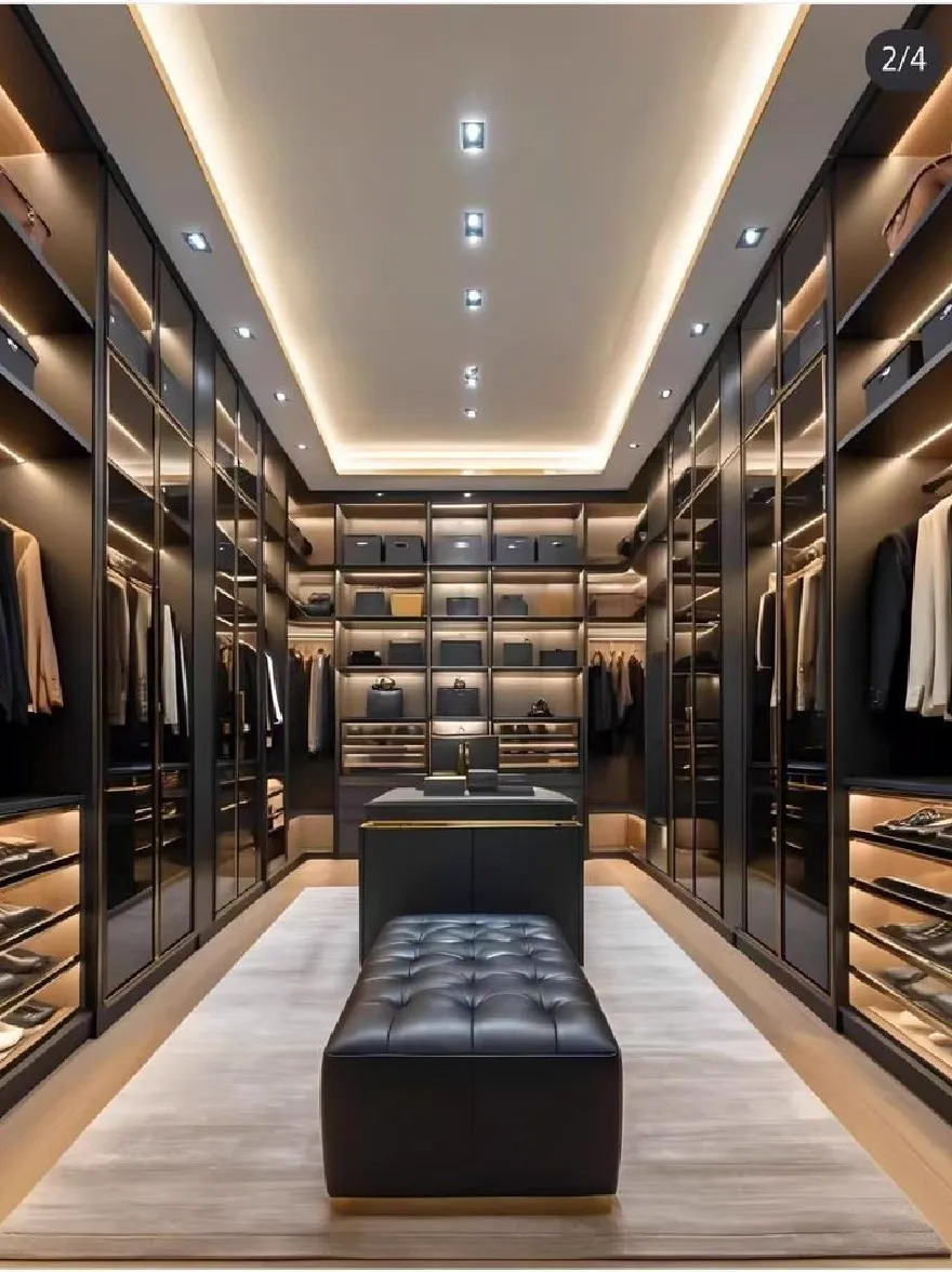 Русский промпт: Роскошный гардероб с черно-золотыми акцентами с гладким и современным дизайном. Полки заполнены аккуратно расположенными туфлями и мешками, а потолок украшен втужденным освещением, создавая теплую и привлекательную атмосферу. Пол покрыт светлым ковром, а черная кожаная скамейка расположена в центре комнаты, обеспечивая удобную зону для сидения. Общая эстетика сложна и сложна, с акцентом на роскошь и изысканности. | Original prompt: A luxurious walk-in closet with black and gold accents, featuring a sleek and modern design. The shelves are filled with neatly arranged shoes and bags, and the ceiling is adorned with recessed lighting, creating a warm and inviting atmosphere. The floor is covered with a light-colored carpet, and a black leather bench sits in the center of the room, providing a comfortable seating area. The overall aesthetic is sophisticated and sophisticated, with a focus on luxury and sophistication.