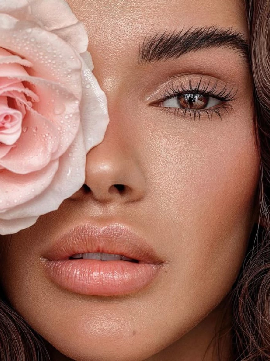 Русский промпт: A close-up photograph of a beautiful African-American woman with light skin and long, wavy brown hair. She has a serene expression, with her eyes closed and her lips slightly parted. She is wearing a light pink rose on her forehead, with water droplets glistening on her skin. The background is a neutral color, allowing the focus to remain on her face and the rose. The lighting is soft and natural, highlighting her delicate features. The image has a watermark in the top left corner. | Original prompt: A close-up photograph of a beautiful African-American woman with light skin and long, wavy brown hair. She has a serene expression, with her eyes closed and her lips slightly parted. She is wearing a light pink rose on her forehead, with water droplets glistening on her skin. The background is a neutral color, allowing the focus to remain on her face and the rose. The lighting is soft and natural, highlighting her delicate features. The image has a watermark in the top left corner.