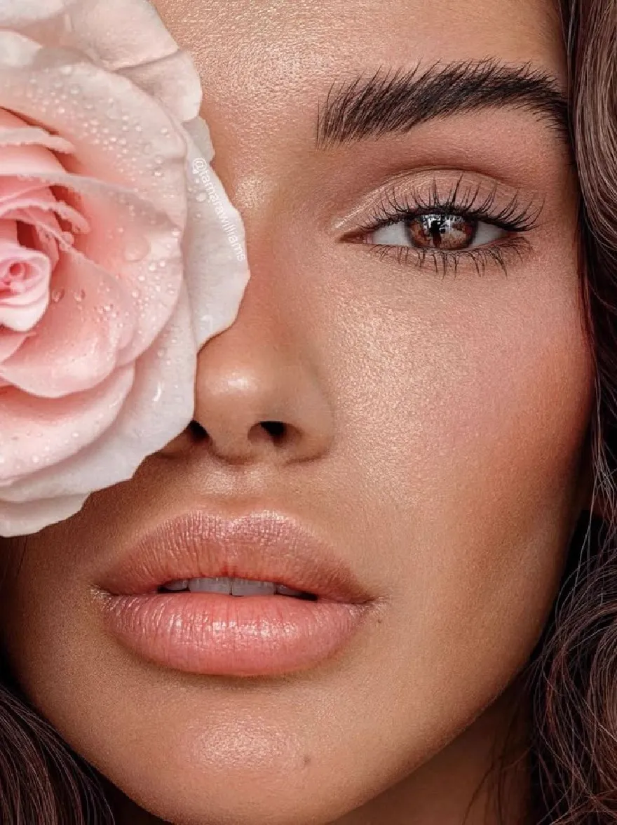 Русский промпт: A close-up photograph of a beautiful African-American woman with light skin and long, wavy brown hair. She has a serene expression, with her eyes closed and her lips slightly parted. She is wearing a light pink rose on her forehead, with water droplets glistening on her skin. The background is a neutral color, allowing the focus to remain on her face and the rose. The lighting is soft and natural, highlighting her delicate features. The image has a watermark in the top left corner. | Original prompt: A close-up photograph of a beautiful African-American woman with light skin and long, wavy brown hair. She has a serene expression, with her eyes closed and her lips slightly parted. She is wearing a light pink rose on her forehead, with water droplets glistening on her skin. The background is a neutral color, allowing the focus to remain on her face and the rose. The lighting is soft and natural, highlighting her delicate features. The image has a watermark in the top left corner.
