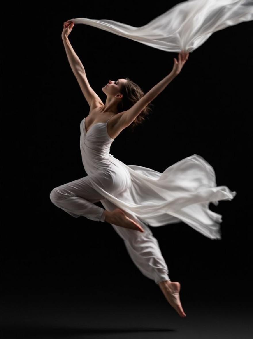 Русский промпт: Фотография изящного балетного танцора в воздухе, в белом, плавном платье. Она изящно прыгает с вытянутыми руками вверх, держа длинную текущую белую ткань, подвешенную в воздухе. Фон - твердый черный, обеспечивающий резкий контраст с изящными движениями танцора. Освещение мягкое и равномерное, подчеркивая ее нежные черты и текущую ткань. У танцора безмятежное выражение, с закрытыми глазами, а рот слегка открылся, как будто в момент блаженного блаженства. Изображение имеет минималистскую эстетику, с чистыми линиями и акцентом на танцовщице и ее движениях. | Original prompt: A photograph of a graceful ballet dancer in mid-air, wearing a white, flowing dress. She is gracefully leaping with her arms stretched upwards, holding a long, flowing white fabric that is suspended in the air. The background is a solid black, providing a stark contrast to the dancer's graceful movements. The lighting is soft and even, highlighting her delicate features and the flowing fabric. The dancer has a serene expression, with her eyes closed and her mouth slightly open, as if in a moment of blissful bliss. The image has a minimalist aesthetic, with clean lines and a focus on the dancer and her movements.